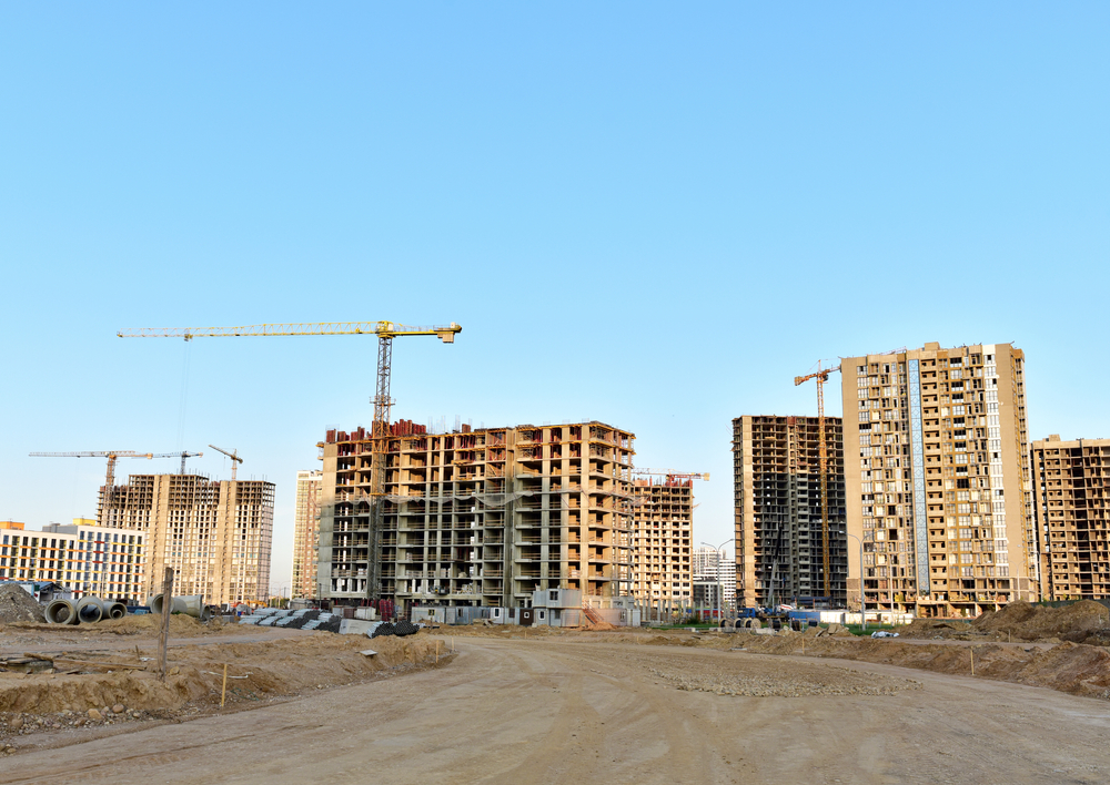 View,of,a,large,construction,site,where,tower,cranes,and