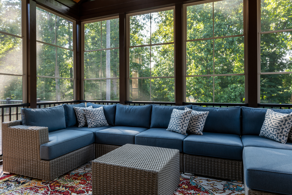 New,modern,screened,porch,with,patio,furniture,,summertime,woods,in